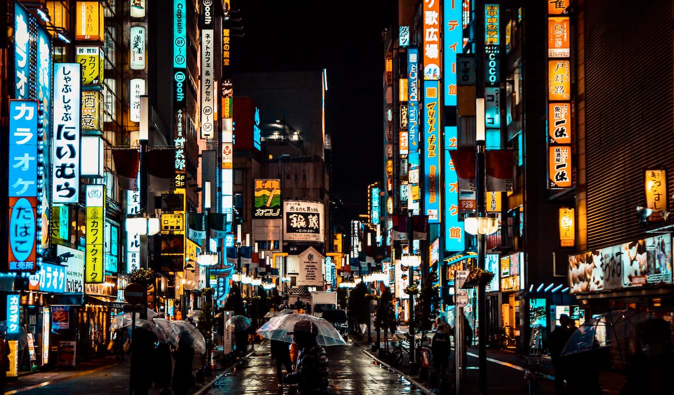 The busy streets of Tokyo, Japan lit up at night by hundreds of bright signs