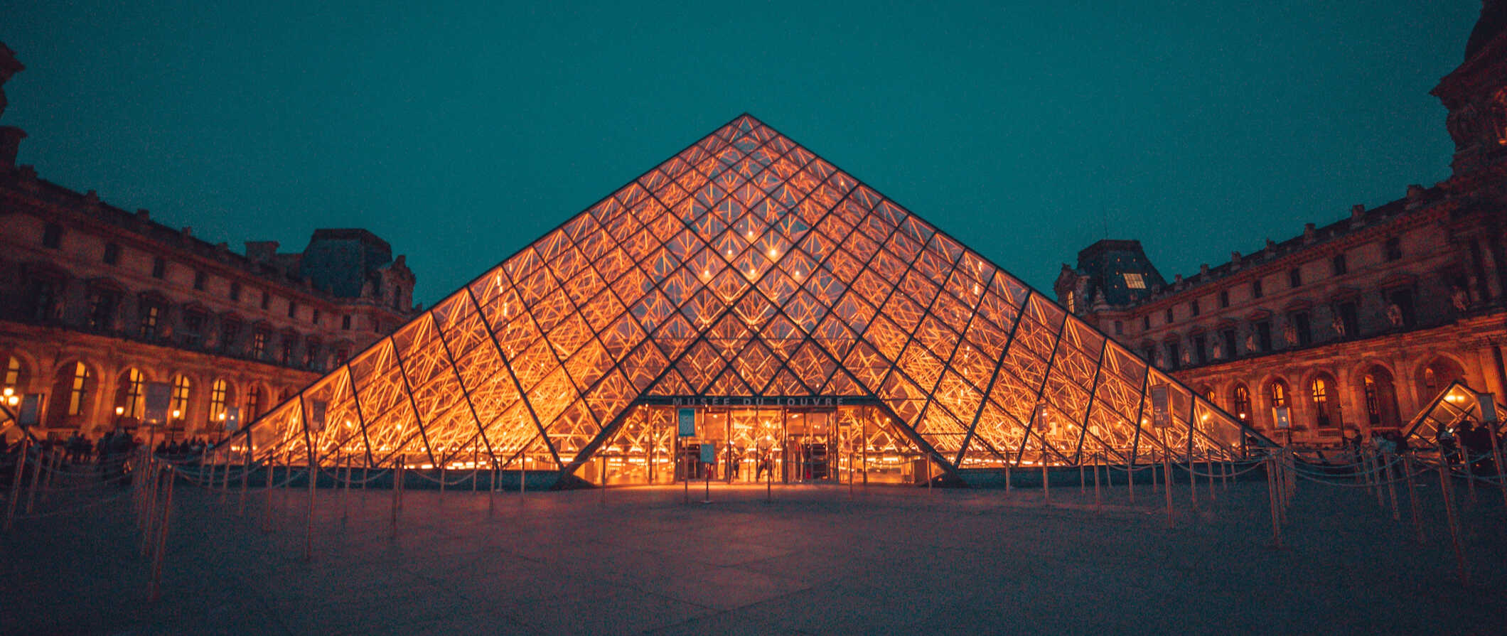 The Louvre pyramid lit up at night in Paris, France