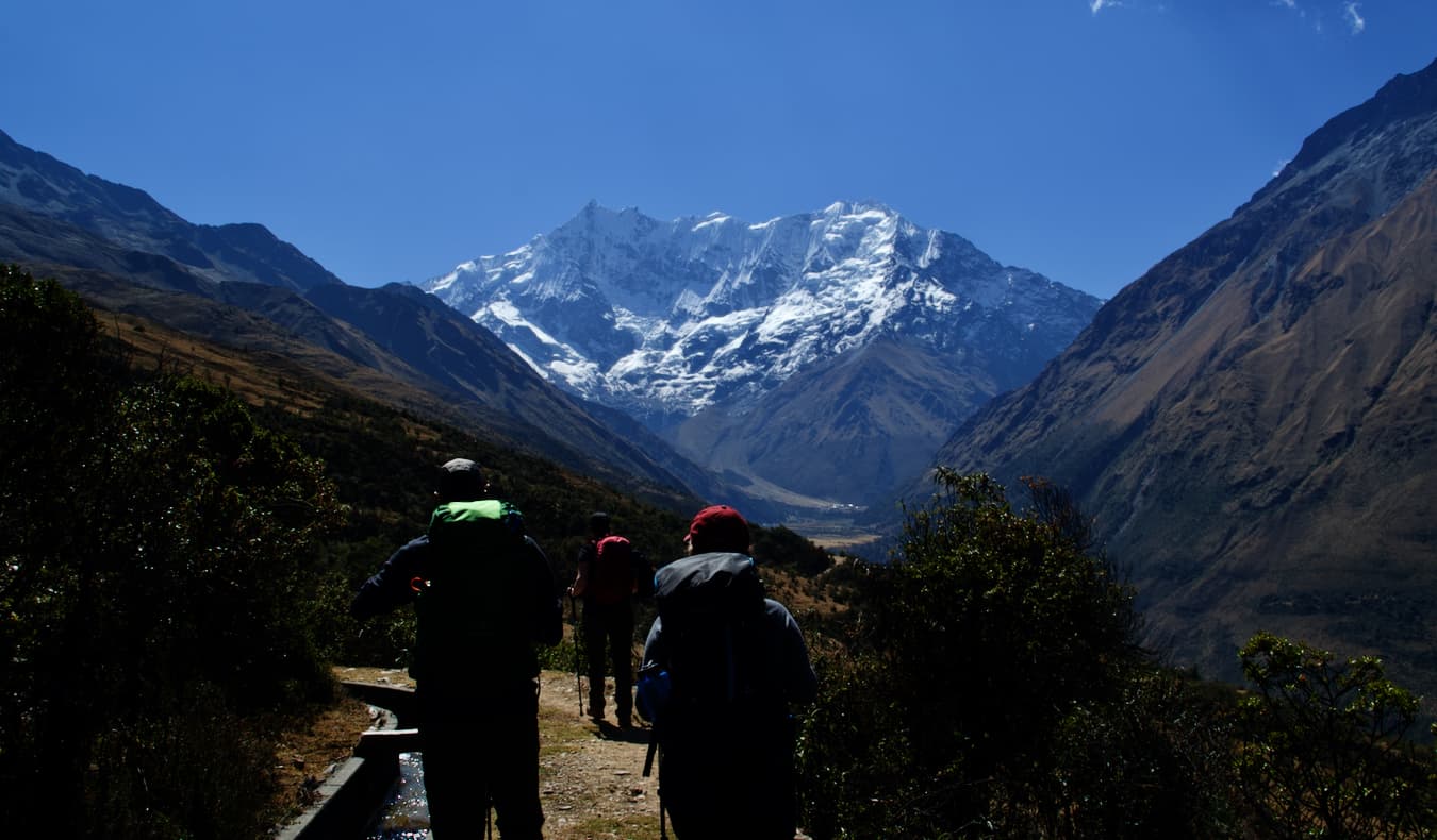 Three travelers embark on the Salkantay trek in Peru on a guided tour