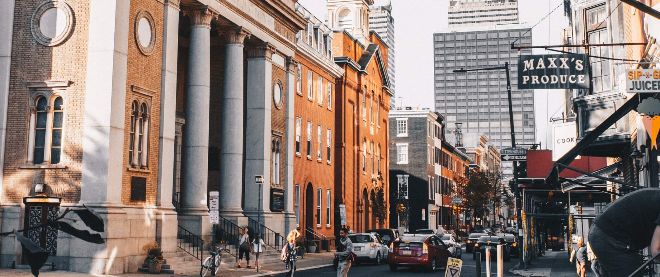 Street with historic buildings and skyscrapers in the background in downtown Philadelphia, USA