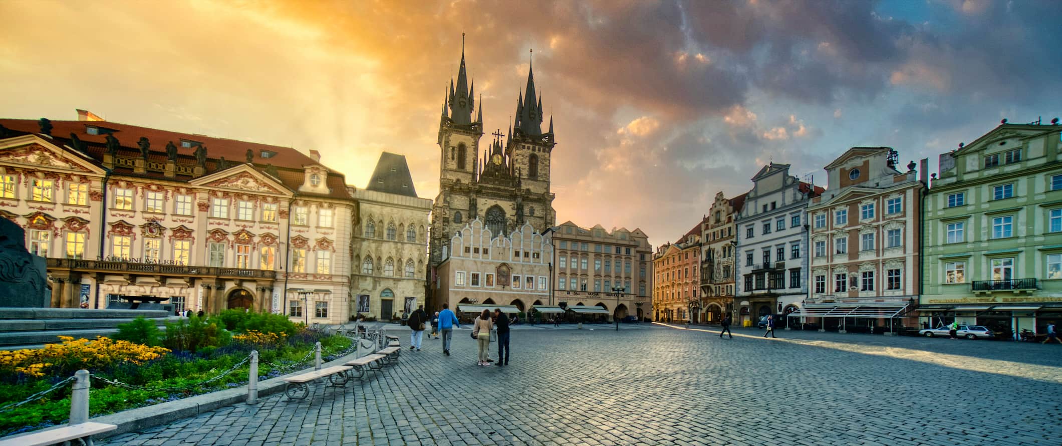 A large historic square without many people during sunset in Prague, Czech Republic