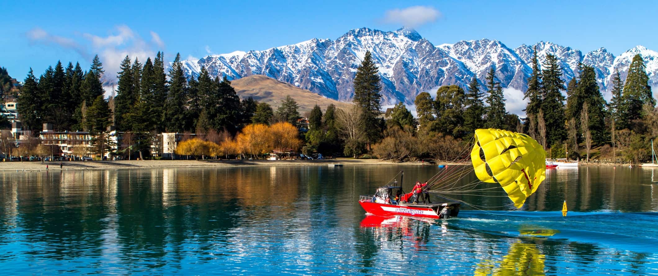 Boat with a parachute behind it in Lake Wakatipu, Queenstown, New Zealand.