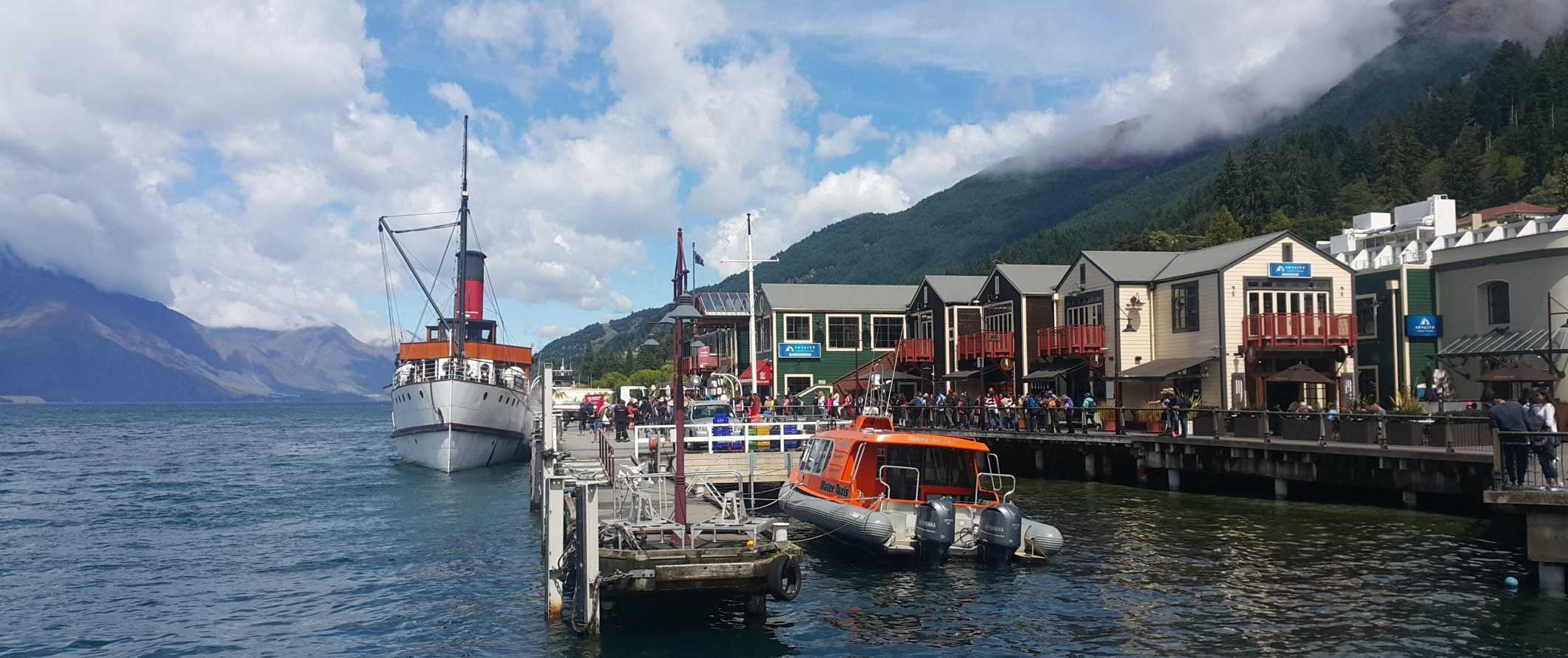 Ferries and other boats in the harbor of Queenstown, New Zealand.