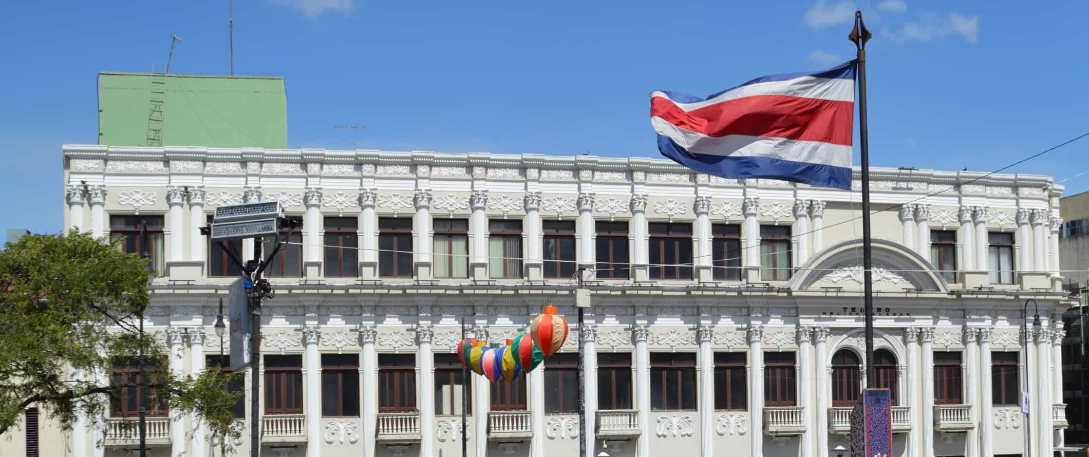 A historic building with the Costa Rican flag flying in front in San Jose, the capital of Costa Rica