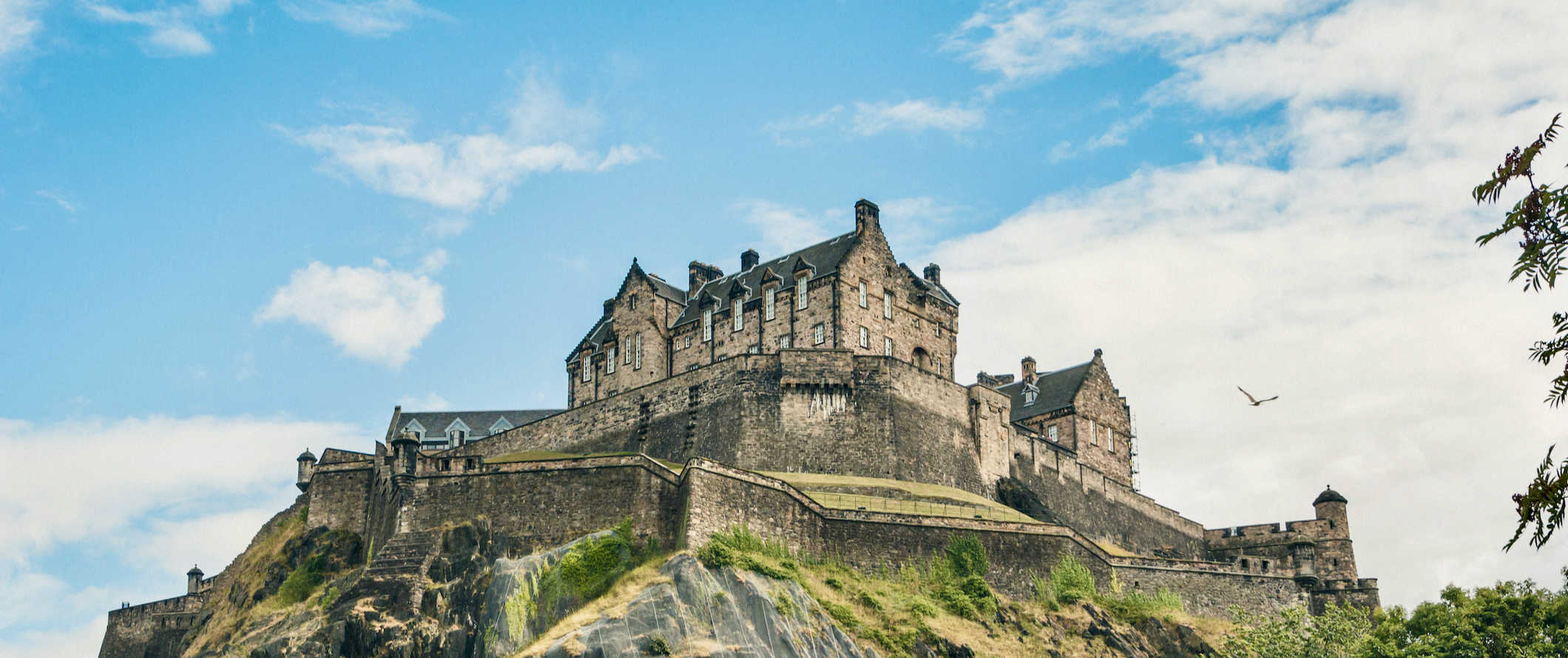 The towering Edinburgh Castle overlooking the city on a sunny day in Scotland