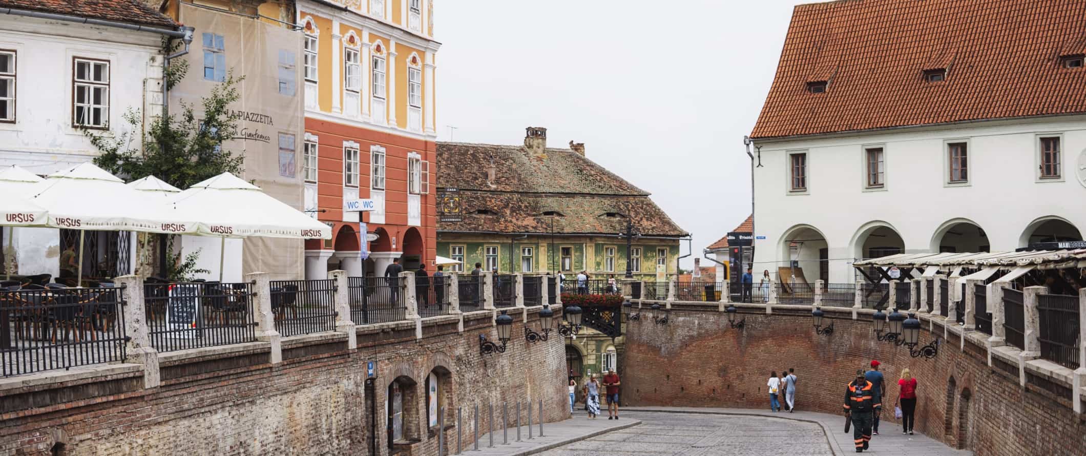 People walking through cobble-stoned streets in Sibiu, Romania