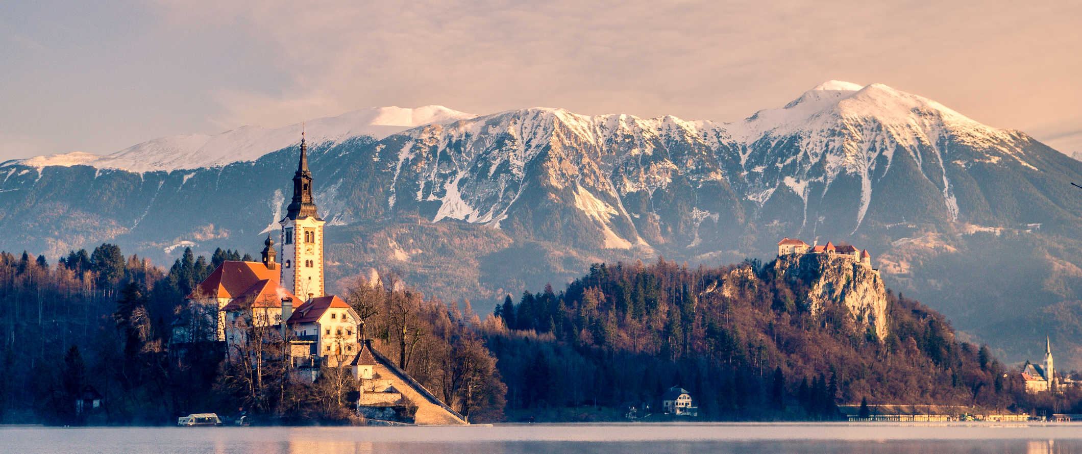 The mountains and lake surrounding the iconic and famous Bled Island in Slovenia