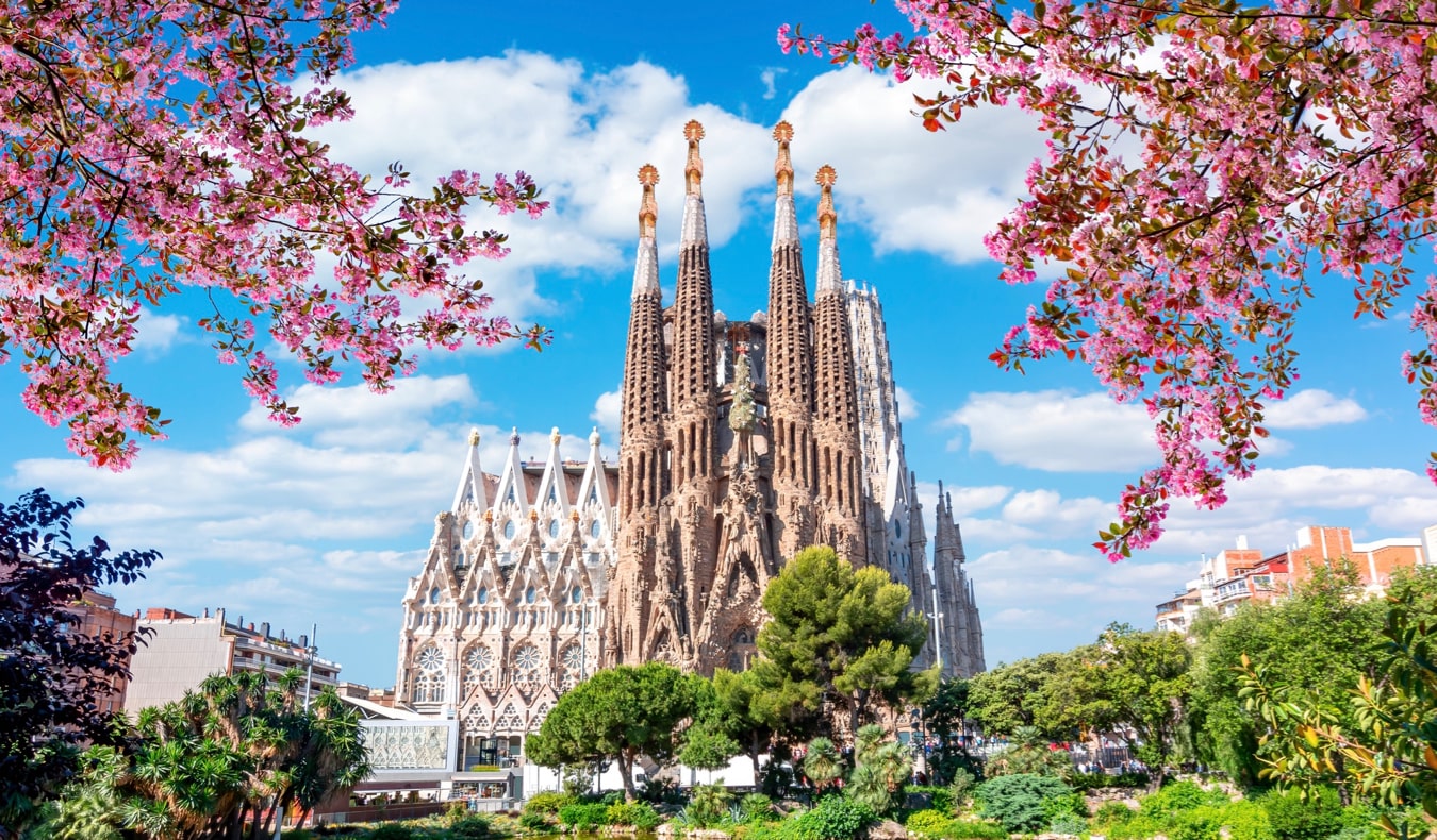 The famous Gaudi cathedral Sagrada Familia in Barcelona, Spain framed by bright flowers