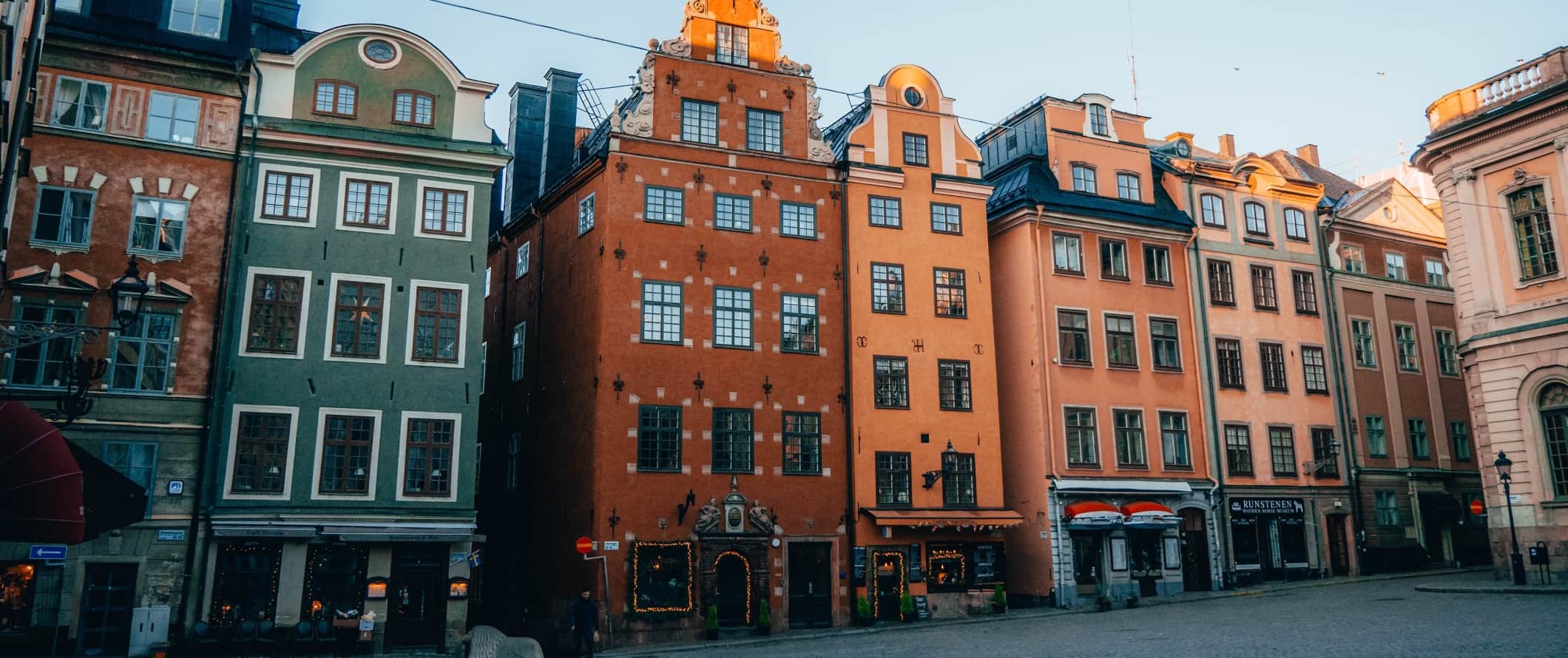 Colorful historic buildings lining a plaza in Gamla Stan, the old town of Stockholm, Sweden