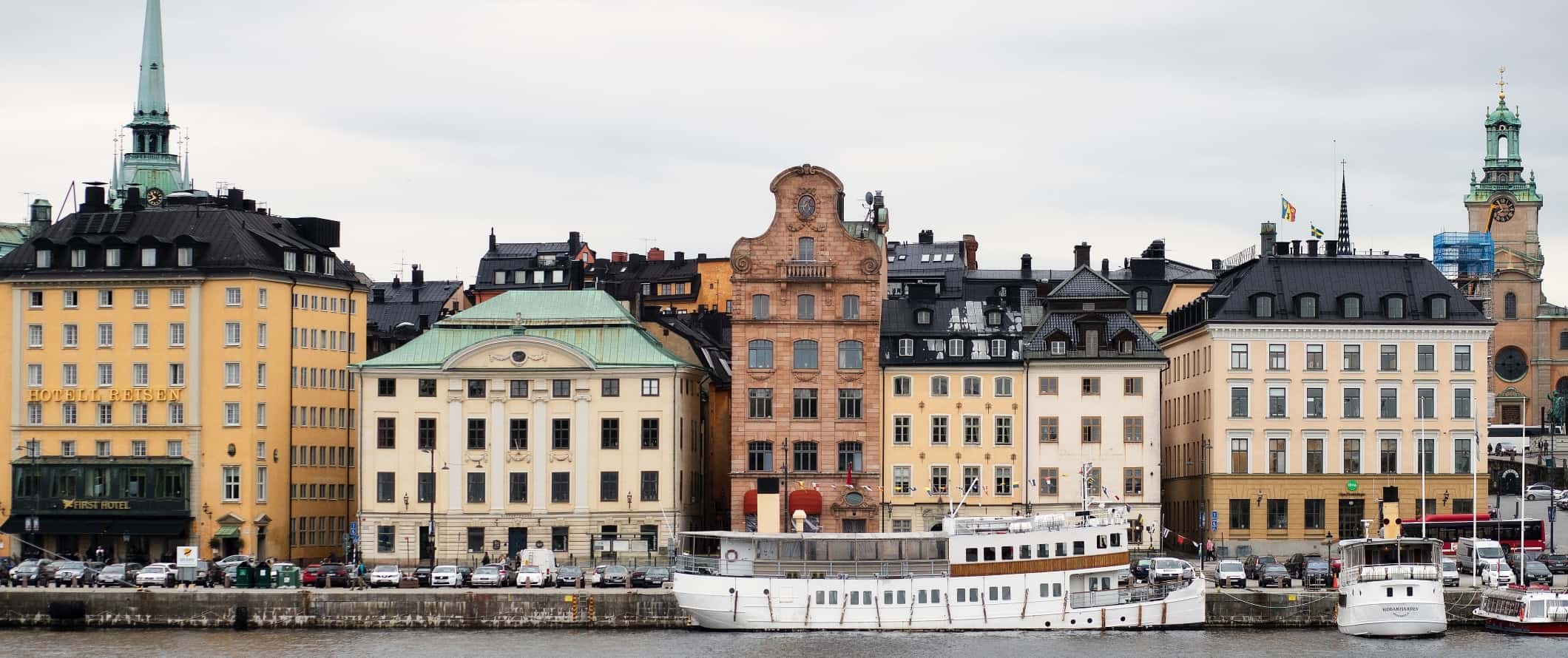 Beige-colored buildings lining the waterfront of Stockholm, Sweden