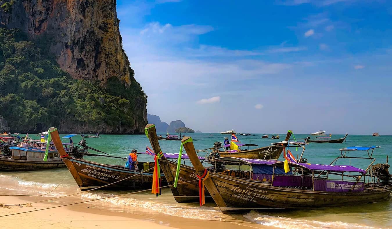 Longtail boats parked on a beautiful beach on an island in Thailand