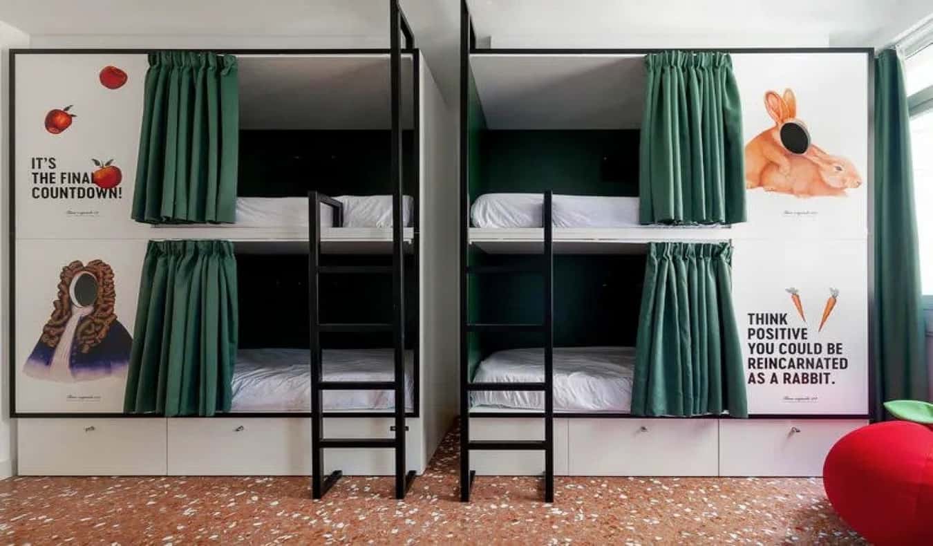 Two pod-style bunk beds with quotes and images of Isaac Newton and rabbits at 2060 The Newton Hostel in Madrid, Spain.