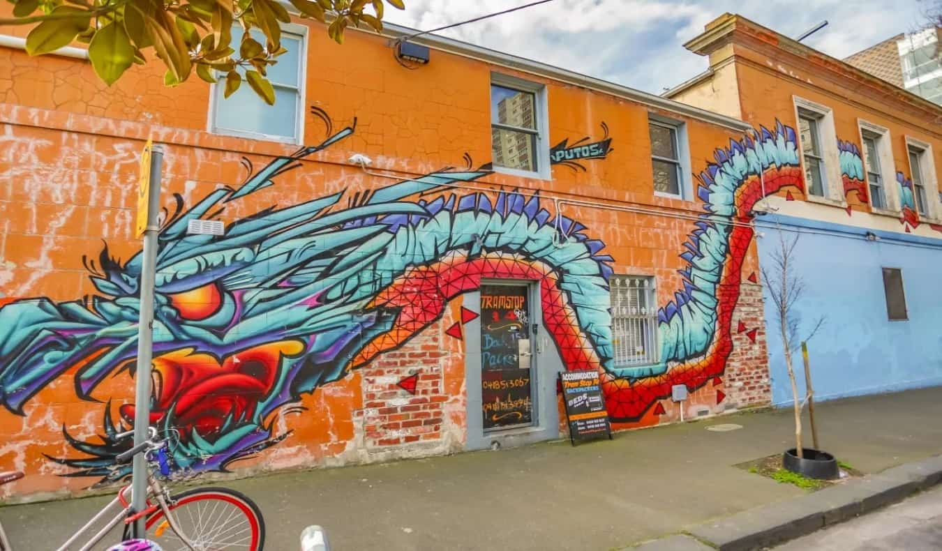 Exterior of Tramstop 14 Backpackers hostel with dragon mural.