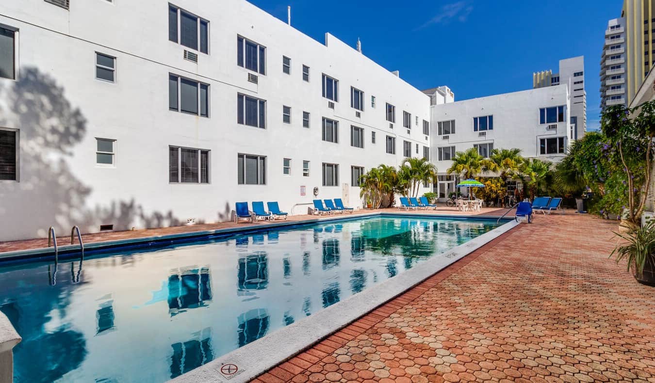 Long Olympic pool and tiled interior courtyard at The Tropics Hotel and Hostel in Miami, Florida
