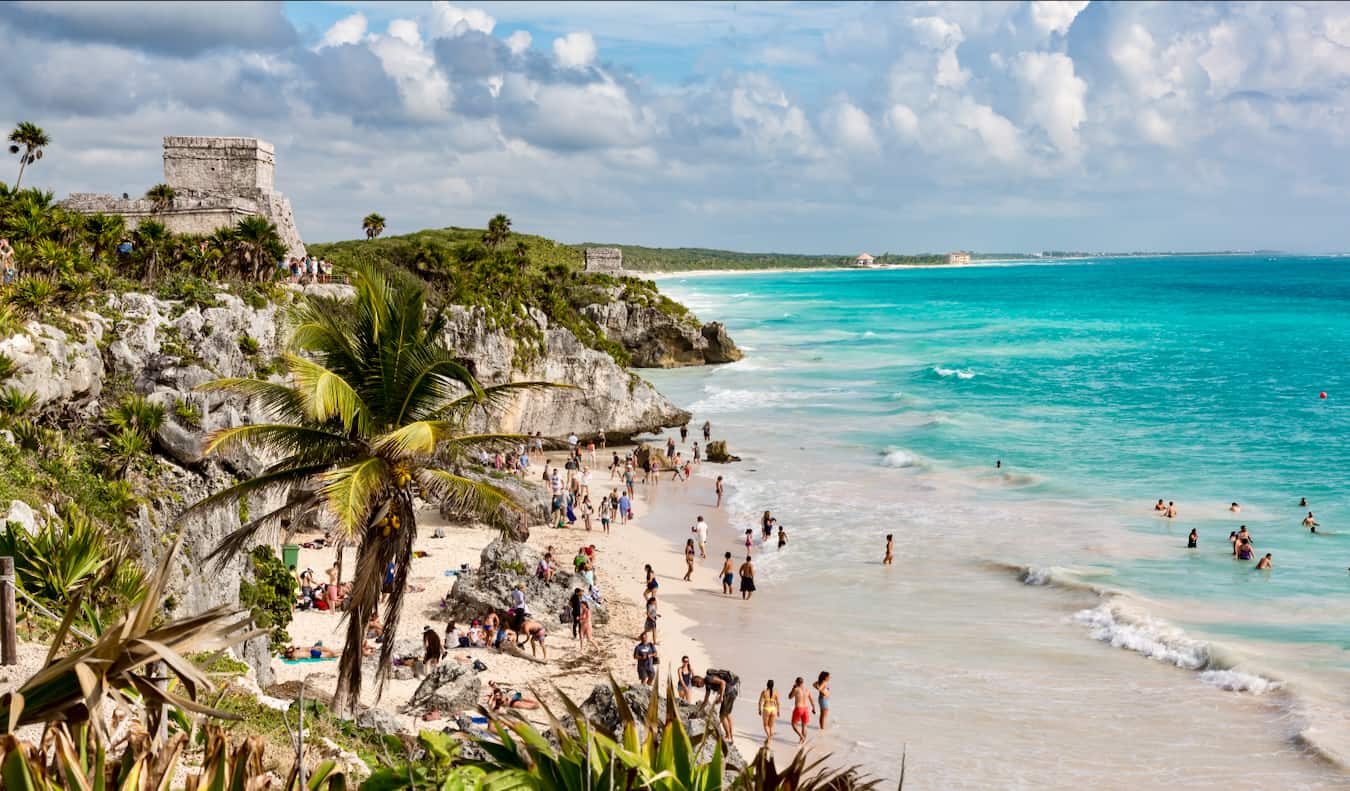 The famous beaches of Tulum, Mexico with Mayan ruins towering on the cliff above