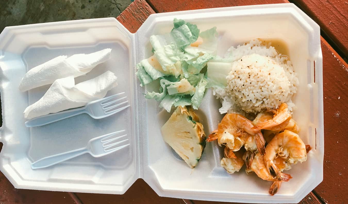 A take out dish of shrimp on a road trip by Nomadic Matt in Hawaii