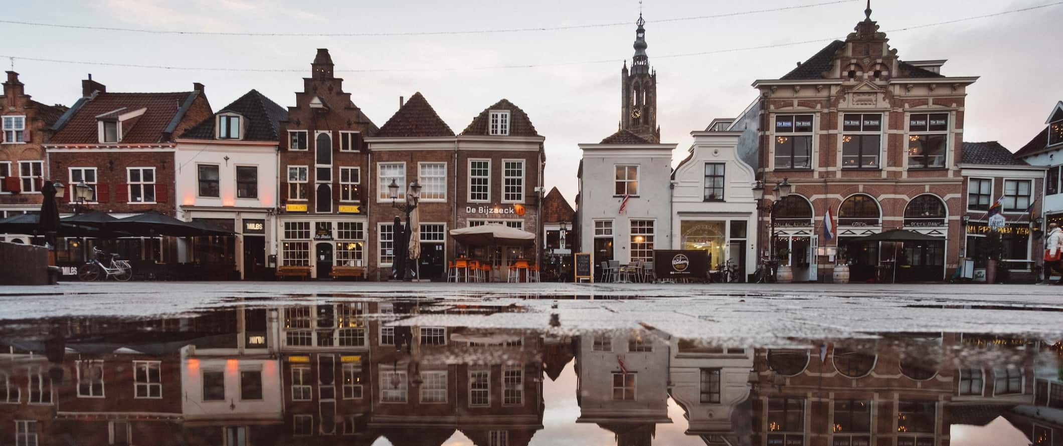 A rainy day in Utrecht, Netherlands featuring a row of old historic buildings