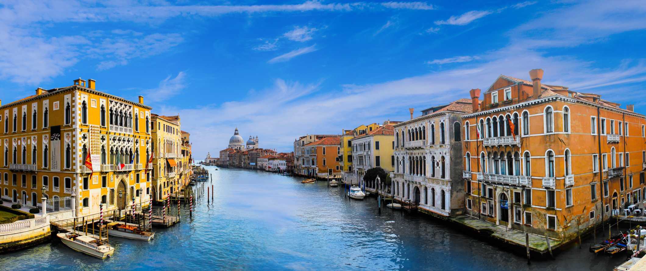 Panoramic views showing the charming, historic canals winding through Venice, Italy.