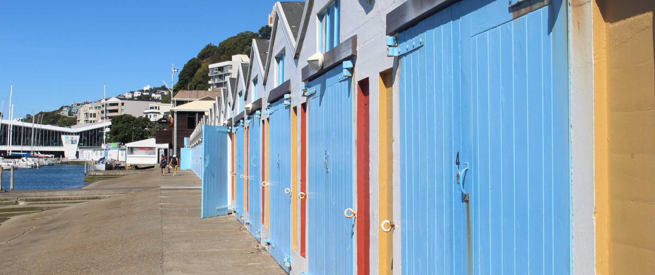 Brightly colored boat and storage huts along the harborfront in Wellington, New Zealand.