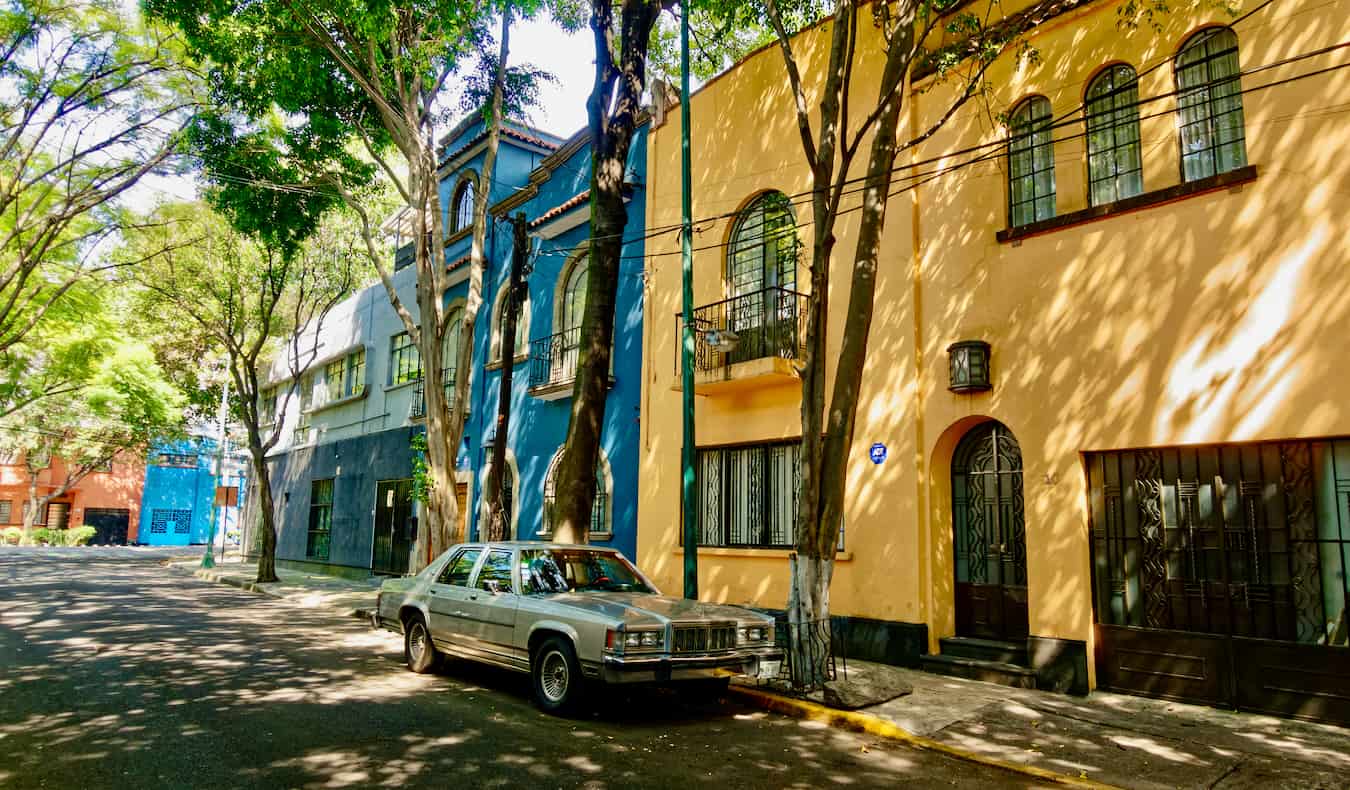 A quiet street with colorful houses in Condesa, Mexico City with a car parked on the street