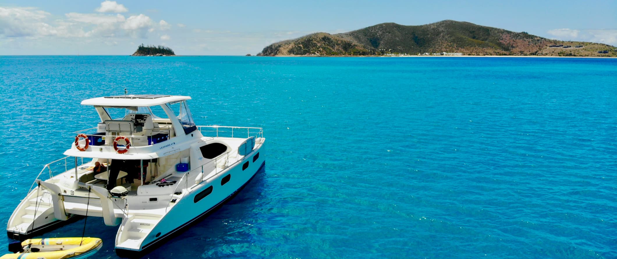 A diving boat anchored out in the pristine waters of the Whitsunday Islands in Australia