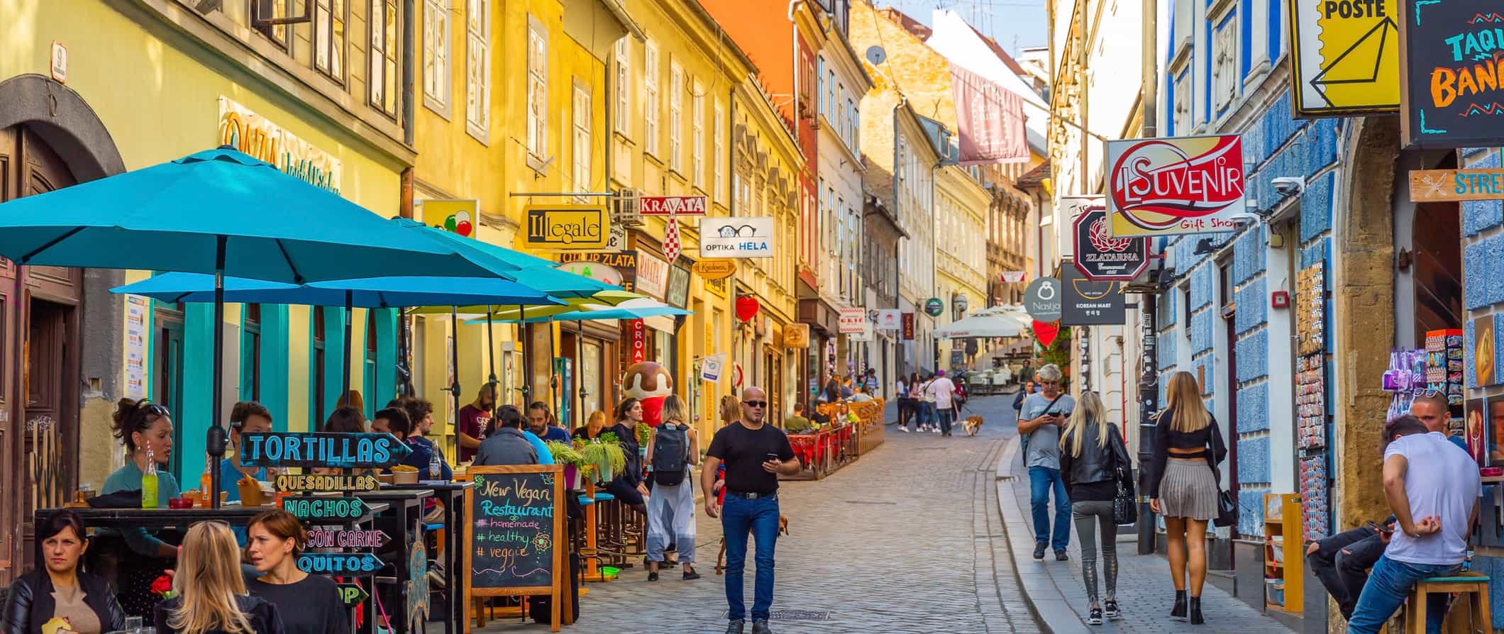 People walking down a narrow street in the Old Town of Zagreb, Croatia