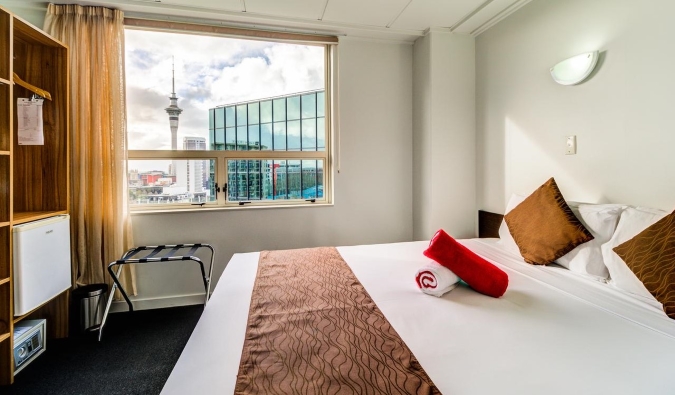 Guestroom at Ascotia Off Queen hotel in Auckland, New Zealand, with an open window looking out over the city skyline
