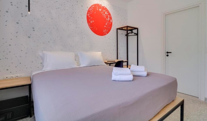 Simply decorated guest room with a red dot on the wall at Athensdot hotel in Athens, Greece