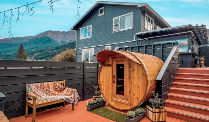 Spherical sauna on a terrace with a large house in the background at the Black Sheep Backpackers Hostel in Queenstown, New Zealand