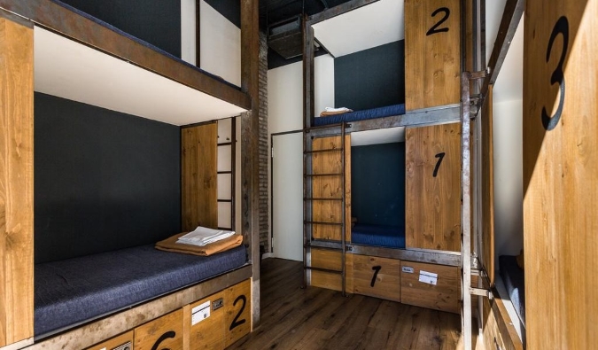 Wooden pod-style bunk beds at Black Swan hostel in Sevilla, Spain