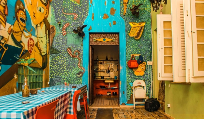Brightly colored kitchen covered in murals at Books Hostel in Rio de Janeiro, Brazil