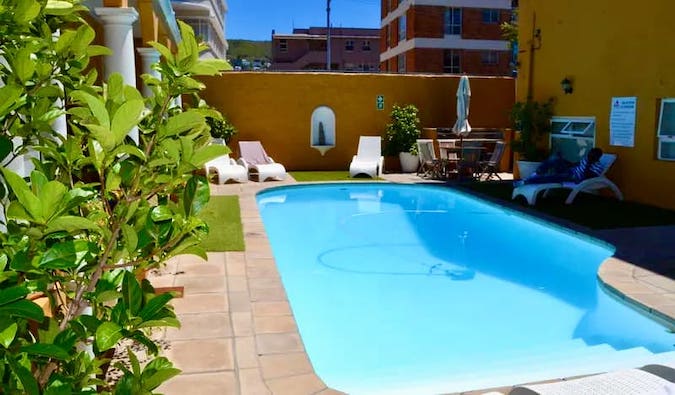 The sunny outside swimming pool at Ashanti Lodge in Cape Town, South Africa