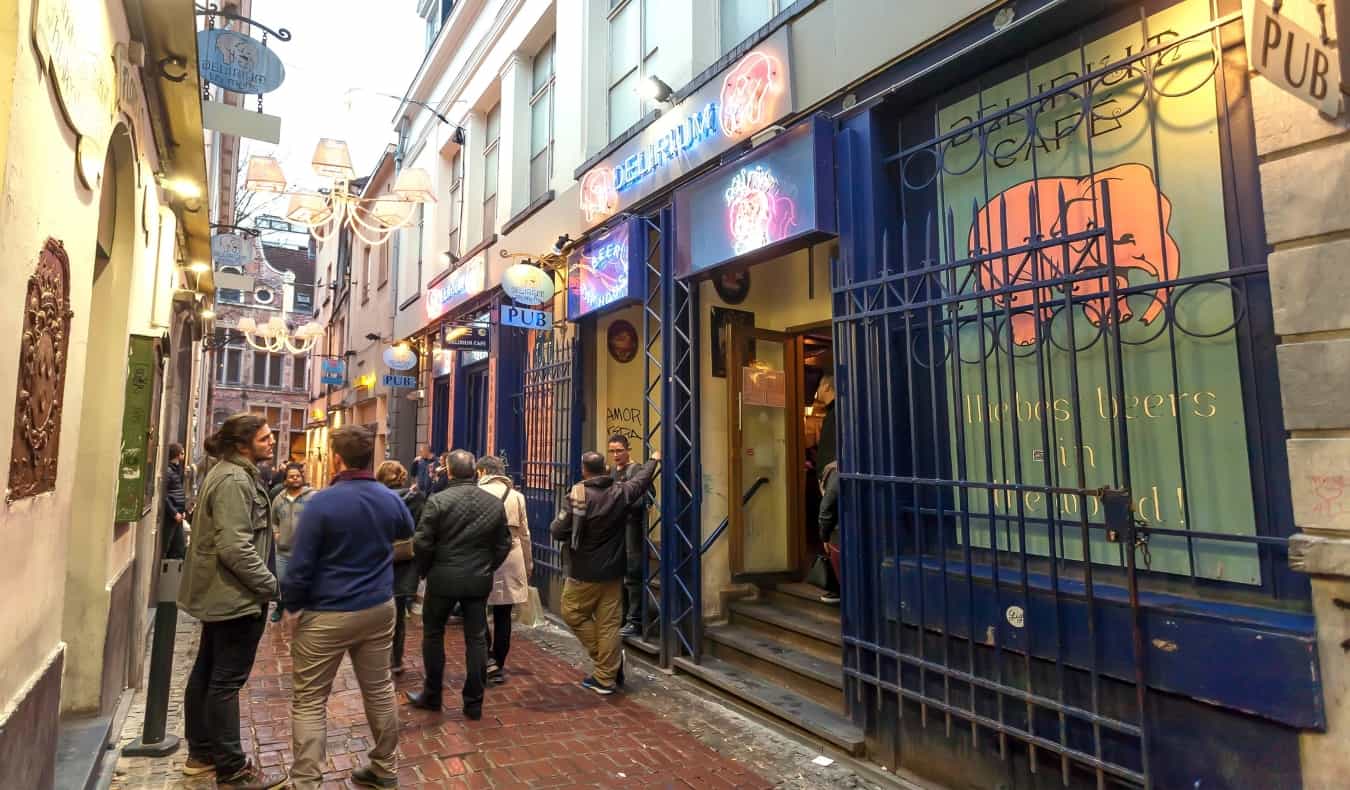 People hanging out and drinking in the alleyway next to Delirium Cafe, a popular brewery in Brussels, Belgium