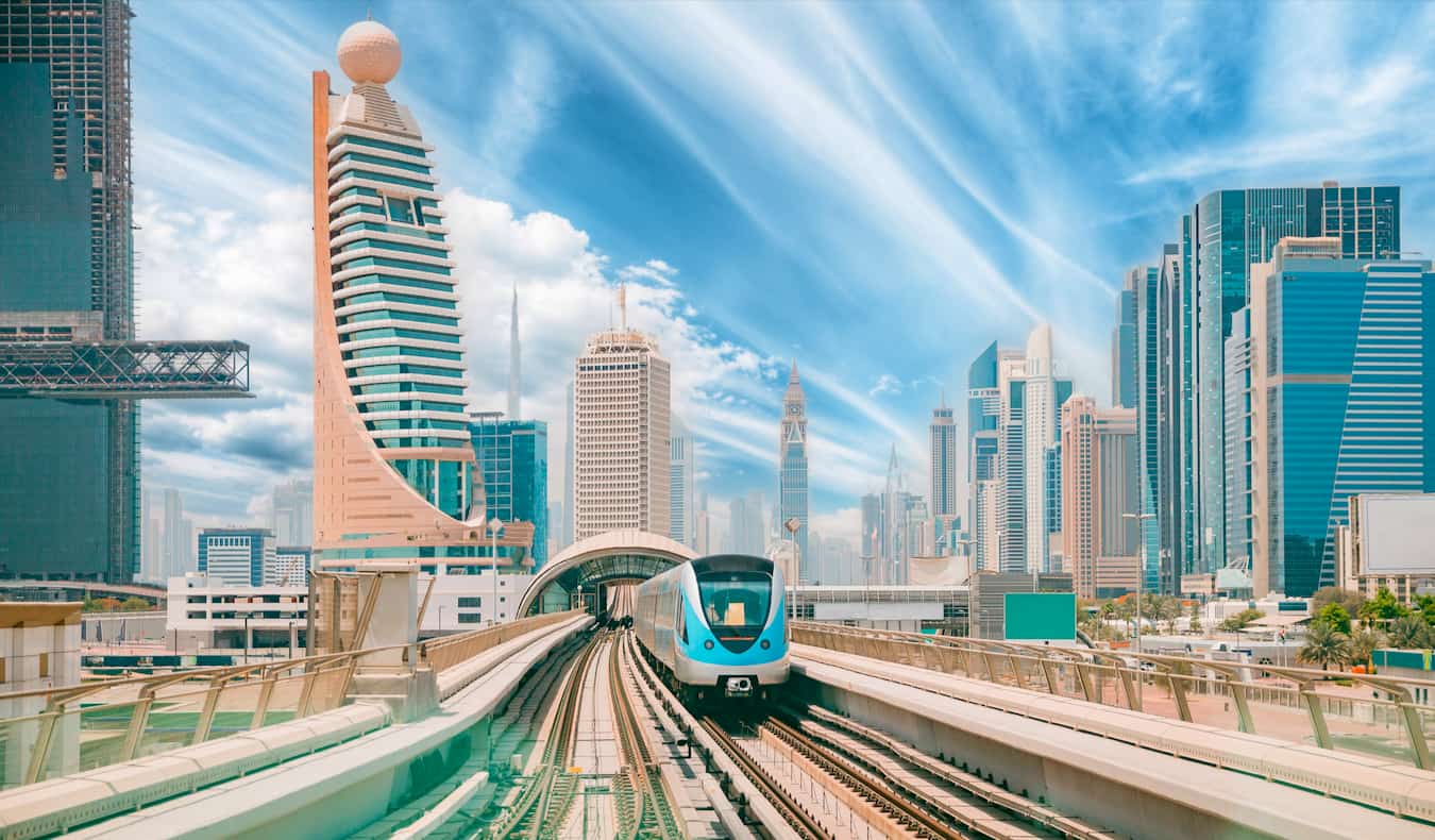 The massive, towering downtown core of Dubai as seen from the busy monorail tracks