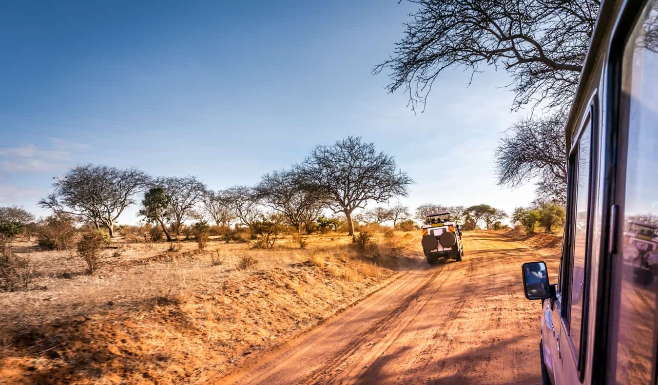 A jeep driving down the savannah plains of Kenya while on safari