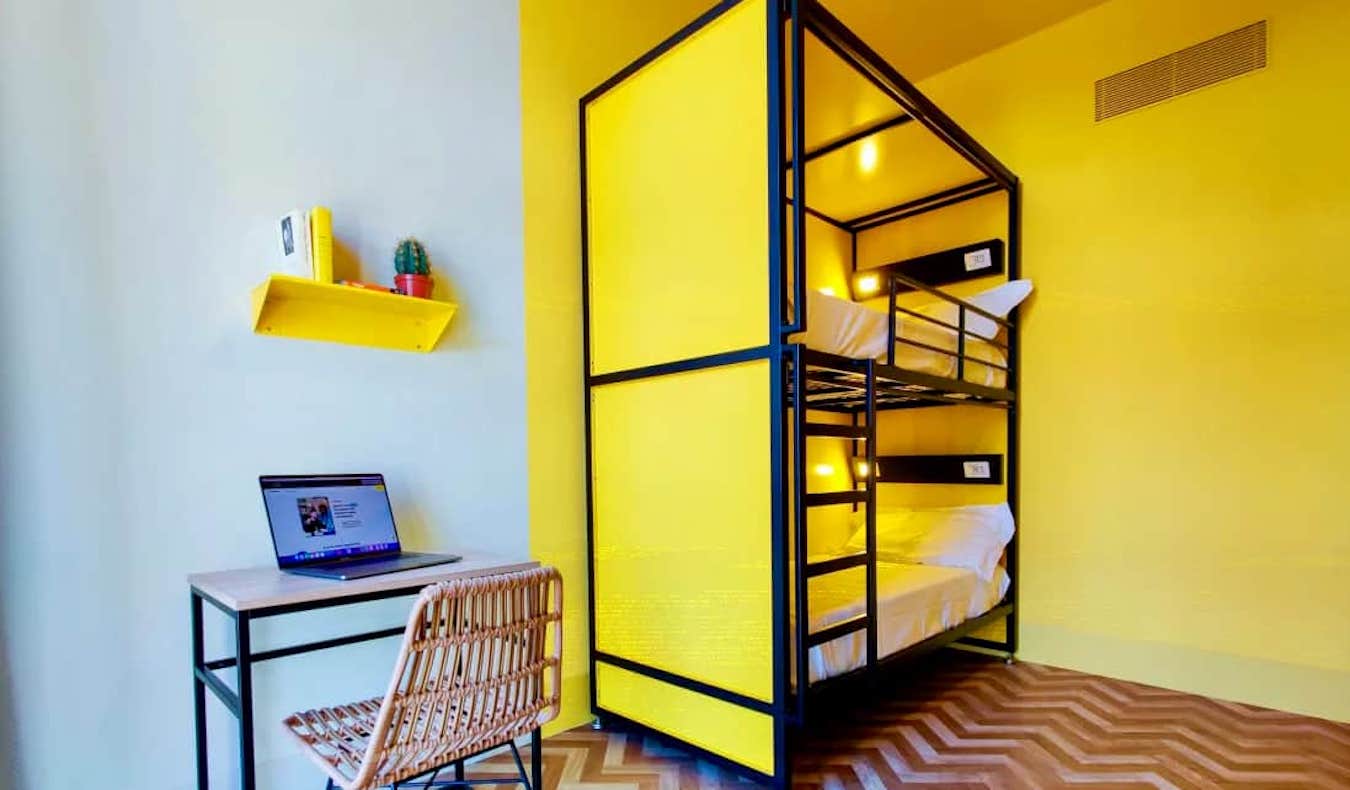 A bright yellow dorm room at YellowSquare hostel in Florence, Italy