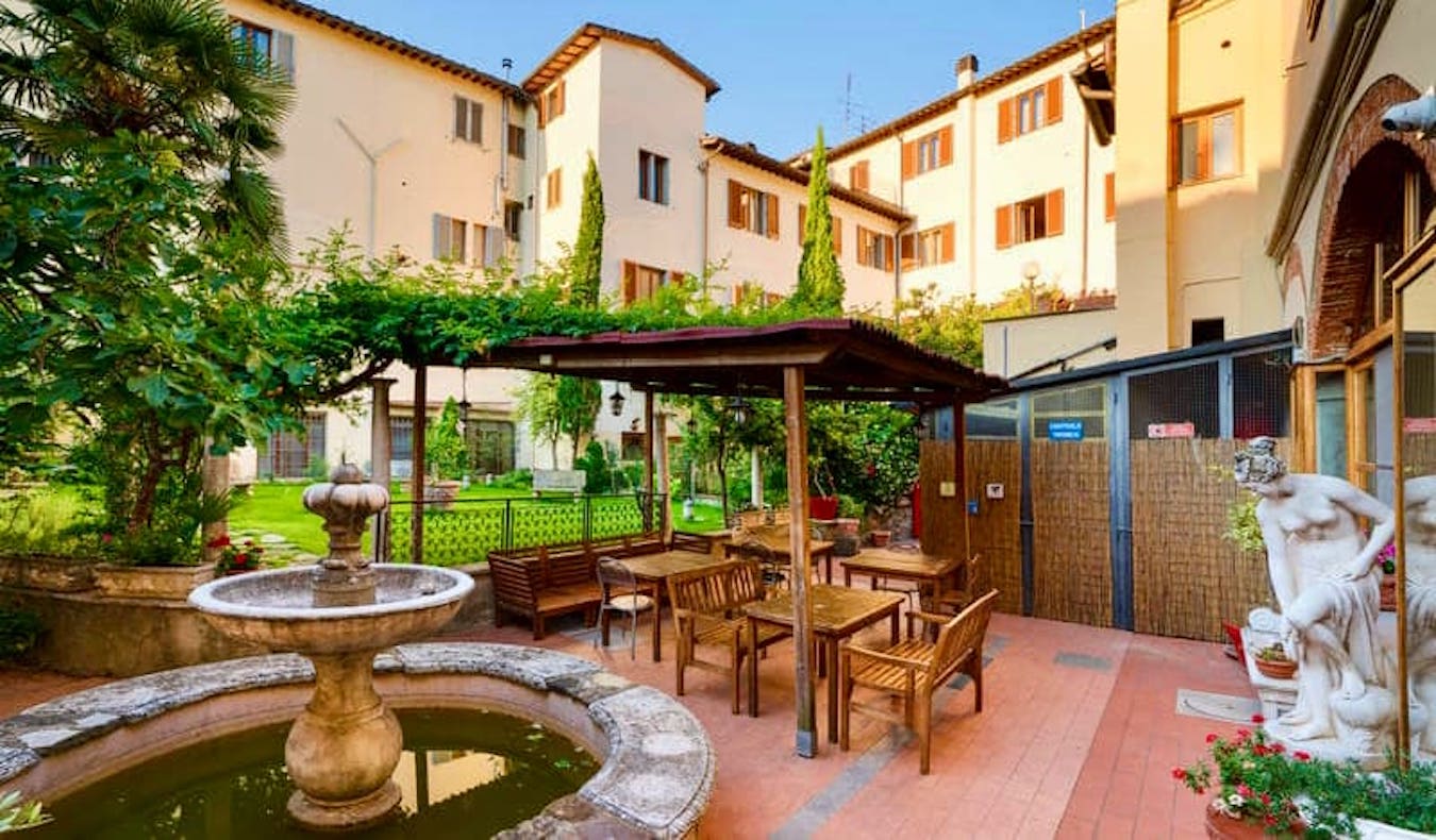 The beautiful courtyard of the Archi Rossi hostel in Florence, Italy