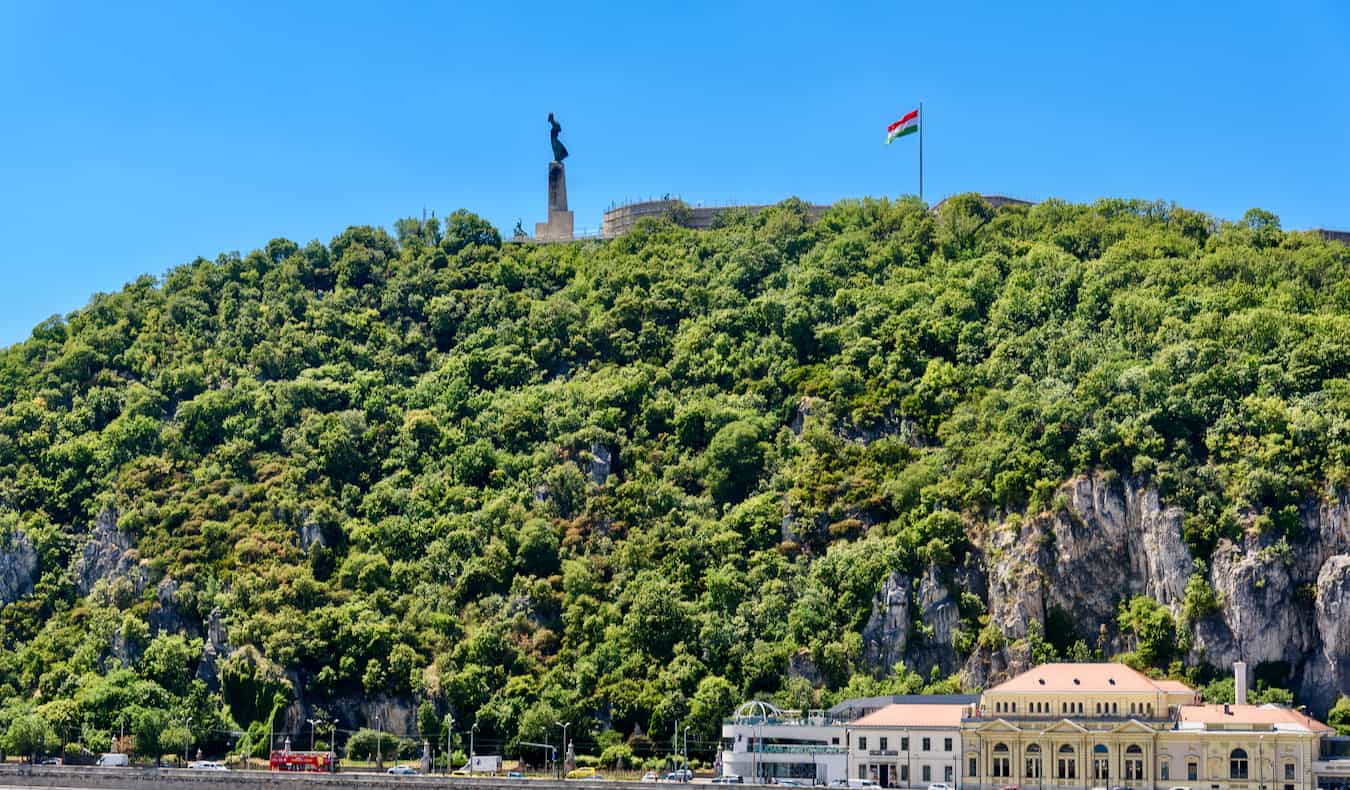 The towering Gellert Hill covered in lush greenery in Budapest, Hungary