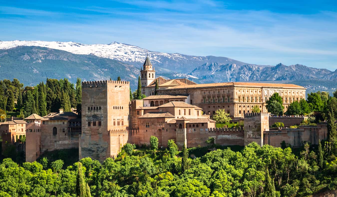 The iconic Alhambra towering over Granada, Spain on a bright and sunny summer day