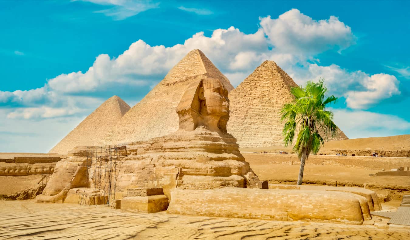 The towering pyramids in the desert of Egypt, with the mysterious Sphinx in the foreground