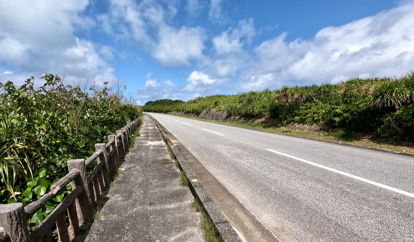 Standing by the side of the road hitchhiking on Okinawa, Japan