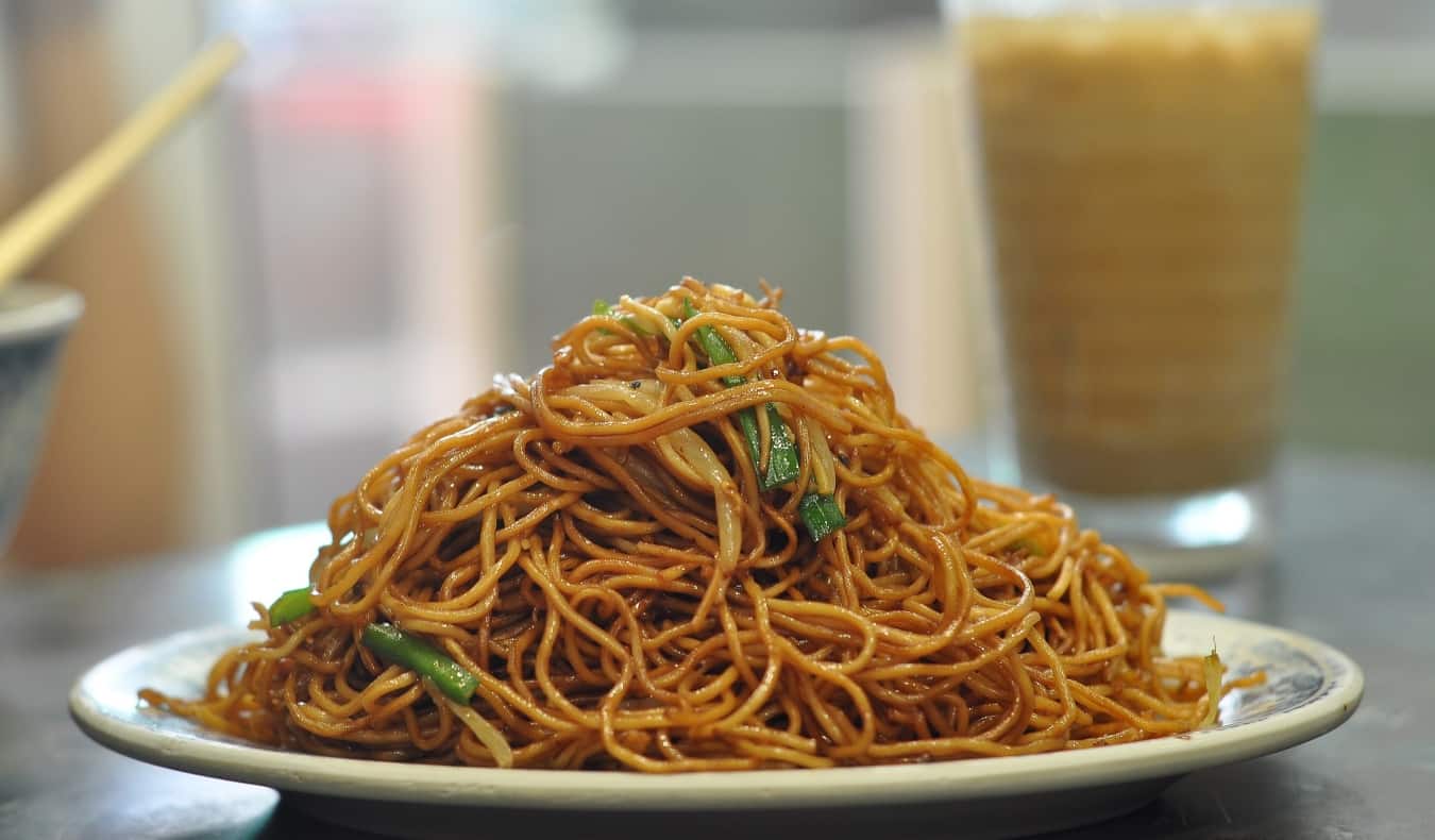 A plate of Hong Kong noodles on a white table