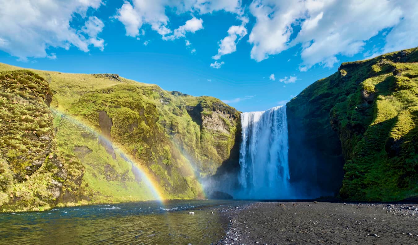 The towering Skogafoss waterfall in sunny rural Iceland