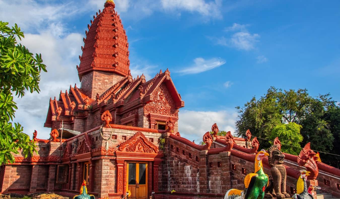 the bright red and ornately decorated Temple Wat Phrai Phatthana in Isaan, Thailand