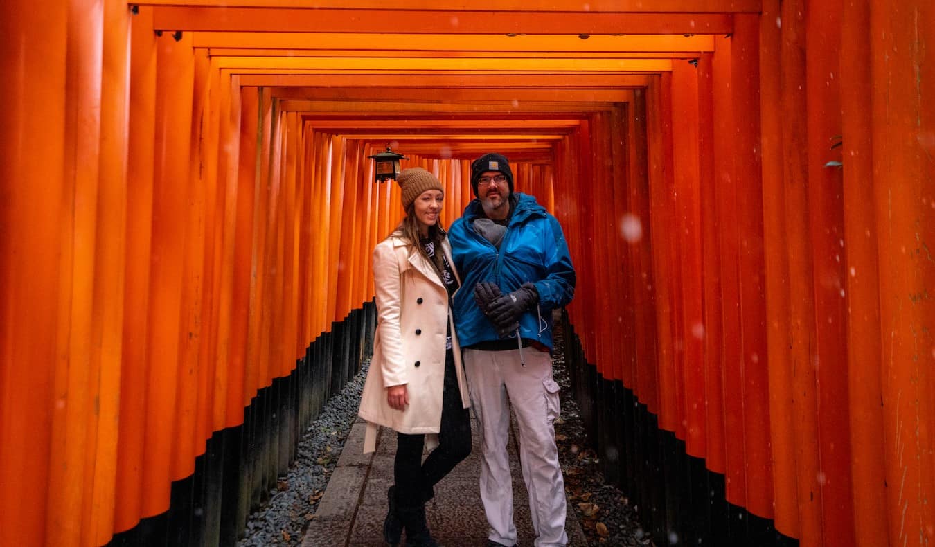 Blogger Kristin Addis of Be My Travel Muse with her partner and baby at Fushimi Inari Shrine in Japan
