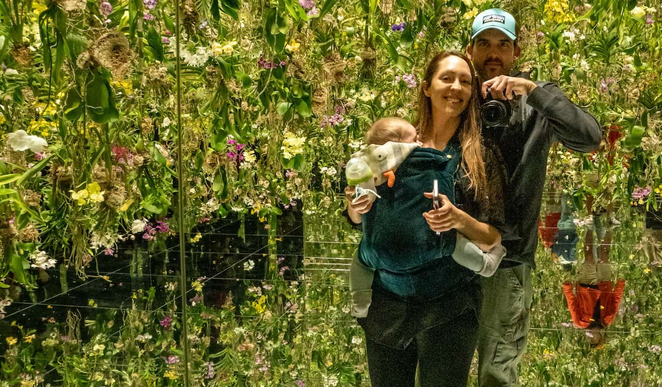 Blogger Kristin Addis of Be My Travel Muse with her partner and victual looking into the mirror at an art installation in Japan