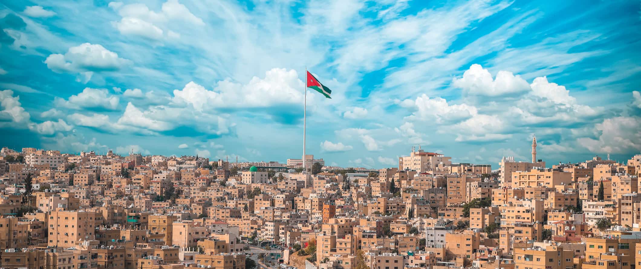 A bright blue sky over Amman, Jordan with a sky blowing in the wind
