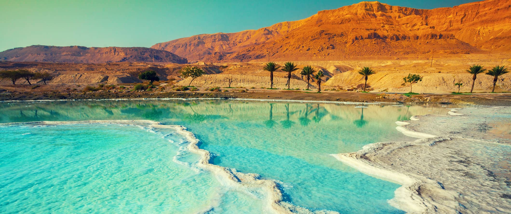 The calm, clear, and salty waters of the Dead Sea in hot, sunny Jordan