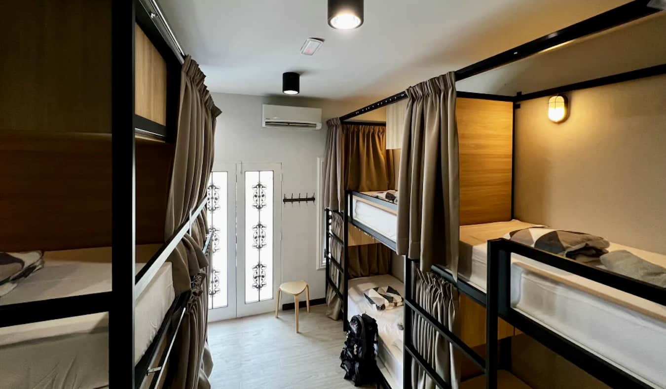 A spacious dorm room with bunk beds at The Freedom Club Hostel in Kuala Lumpur, Malaysia