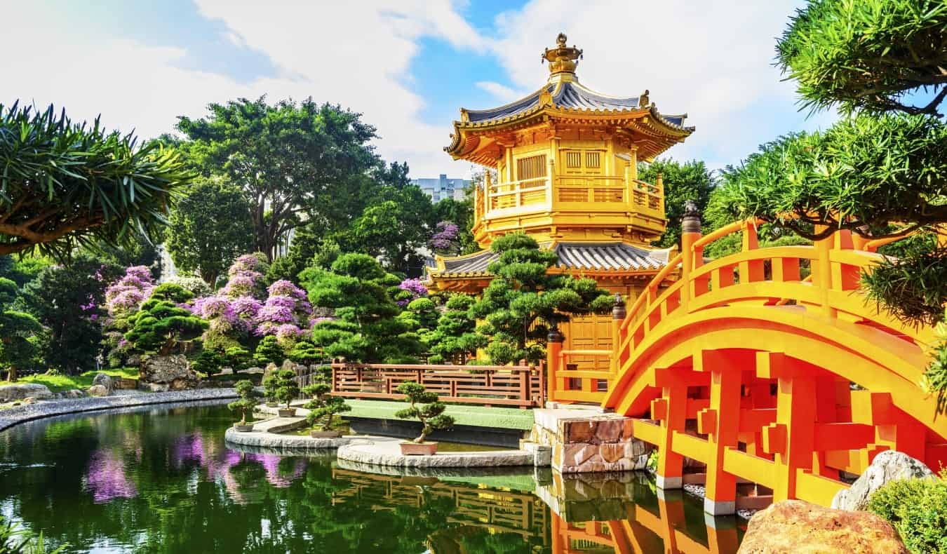 golden pagoda with a bridge going over a reflecting pool at Nan Lian Garden in Kowloon Park, Hong Kong